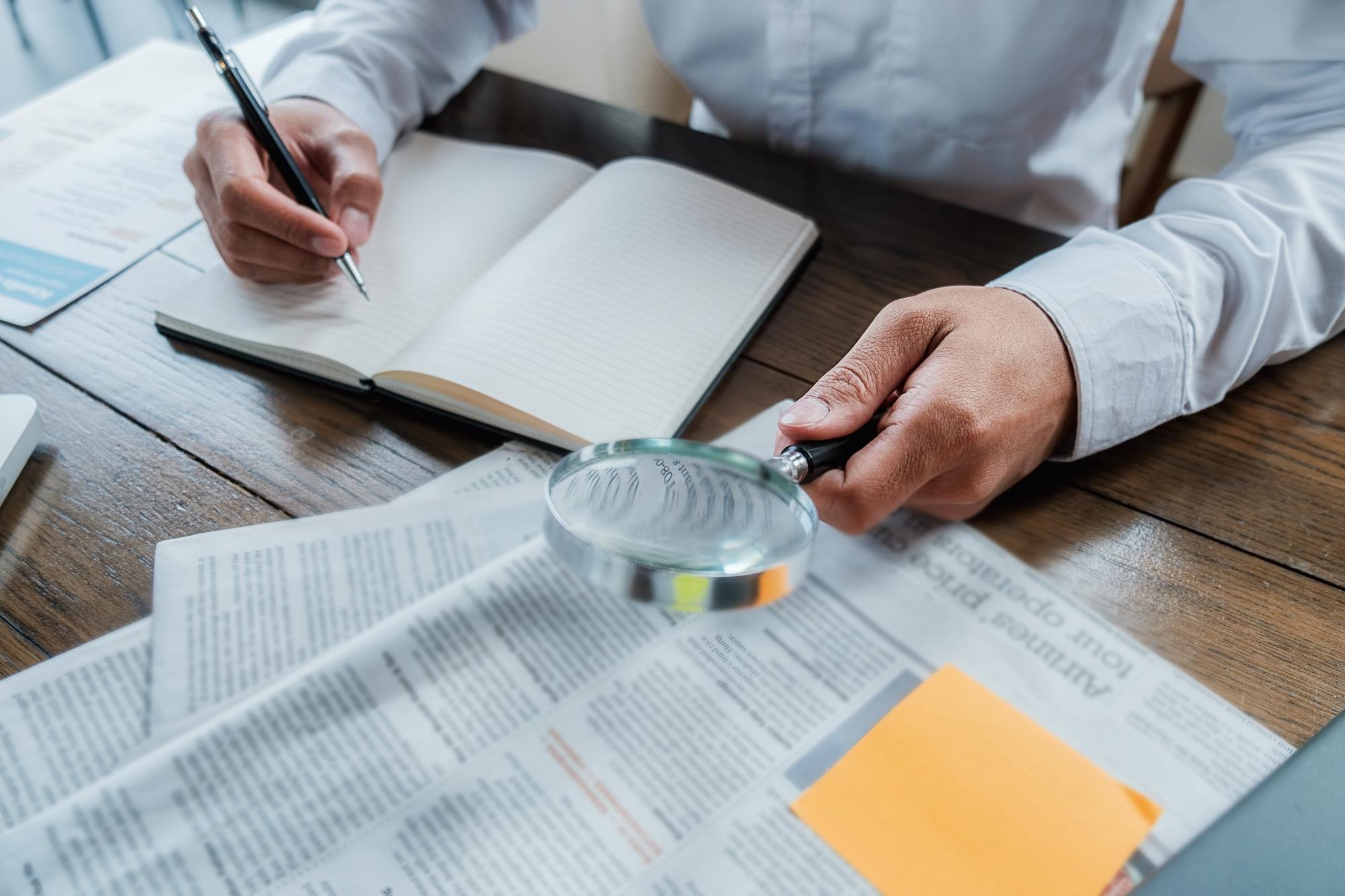 Notebook and magnifier over documents